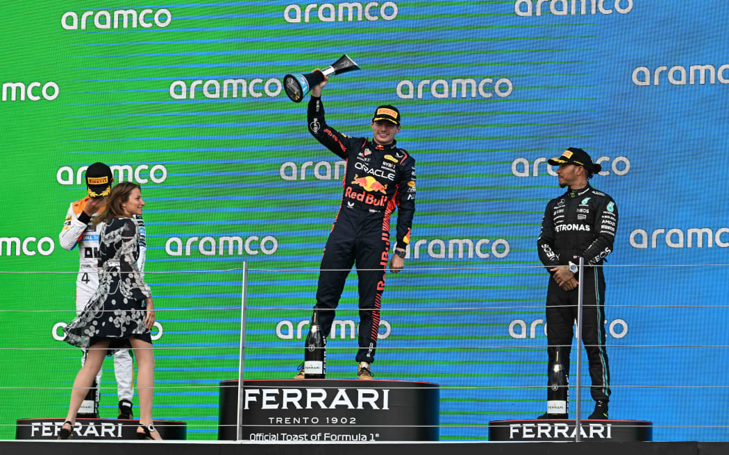 Max Verstappen of the Red Bull Racing team raises the winners trophy after winning the British Grand Prix 2023.