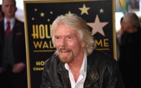 Sir Richard Branson poses on his star at his Hollywood Walk of Fame star unveiling ceremony, October 16, 2018 in Hollywood, California.