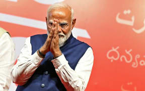 India’s Prime Minister Narendra Modi gestures at the Bharatiya Janata Party (BJP) headquarters to celebrate the party’s win in country's general election, in New Delhi on June 4, 2024. Modi claimed election victory for his party and its allies on June 4, but the opposition said they had "punished" the ruling party to confound predictions and reduce their parliamentary majority. (Photo by Money SHARMA / AFP)
