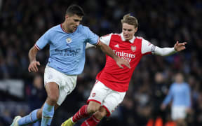 Rodri of Manchester City (L) takes on Martin Odegaard of Arsenal.