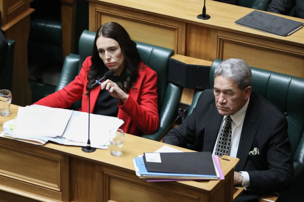 Jacinda Ardern and Winston Peters listen to a question