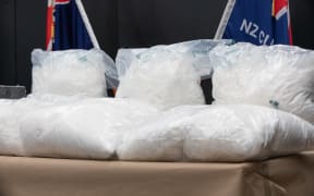 Two men have been arrested over an attempt to smuggle 110kg of methamphetamine and two handguns into New Zealand inside golf cart batteries.