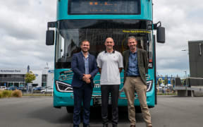 Chair Deon Swiggs, Councillor Joe Davies and corporate and public transport director Giles Southwell stand proudly in front of the new bus.