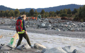 Volunteers pick up rubbish where a disused Fox River landfill spilled litter on the West Coast.