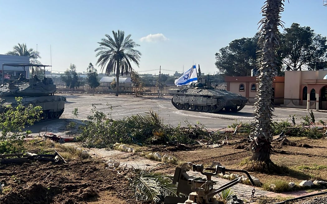 This handout picture released by the Israeli army shows the 401st Brigade's combat team tanks entering the Palestinian side of the Rafah border crossing between Gaza and Egypt in the southern Gaza Strip on May 7, 2024. The Israeli army said it took "operational control" of the Palestinian side of the Rafah border crossing on May 7 and that troops were scanning the area. (Photo by Israeli Army / AFP) / === RESTRICTED TO EDITORIAL USE - MANDATORY CREDIT "AFP PHOTO / Handout / Israeli Army' - NO MARKETING NO ADVERTISING CAMPAIGNS - DISTRIBUTED AS A SERVICE TO CLIENTS ==