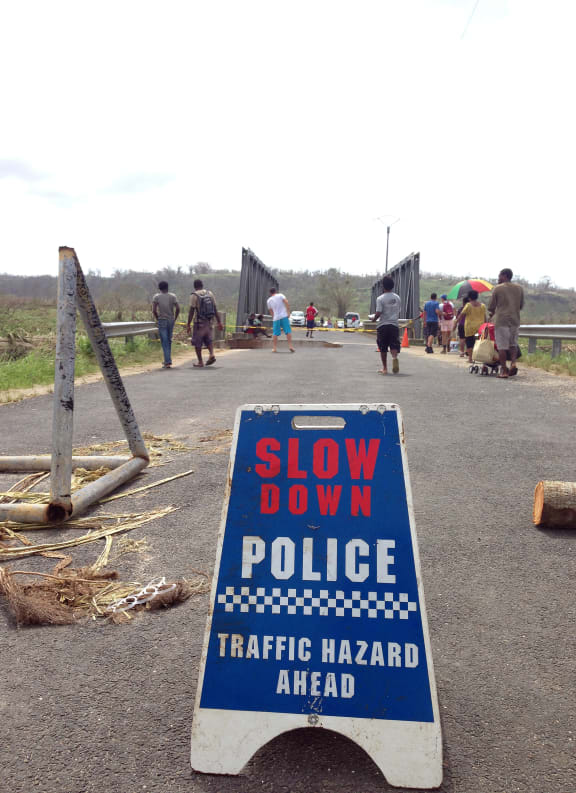 Police block access to a bridge that was badly damaged by Cyclone Pam, near the Vanuatu capital of Port Vila.
