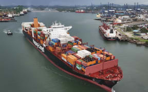 A cargo ship sails through the Panama Canal, in Panama City, Thursday, June 13, 2024.