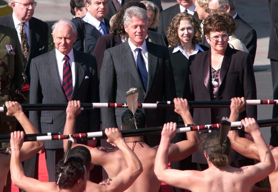 US President Bill Clinton (2nd L) with daughter Chelsea (2nd R), watch a traditional Maori welcome as New Zealand's Prime Minister Jenny Shipley (R) looks on at Auckland Airport 11 September 1999 after arriving in the country to attend APEC