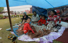 A Nepalese family in a makeshift shelter.