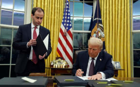 President Donald Trump signs a flurry of executive orders in the White House on Monday.