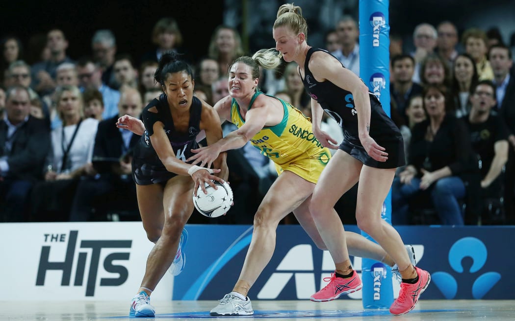 Temalisi Fakahokotau of New Zealand competes for the ball against Australia's  Caitlin Bassett.