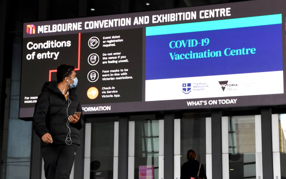 A man walks past a Covid-19 vaccination centre in Melbourne.