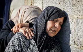 Relatives mourn during the funeral of Al Jazeera cameraman Samer Abu Daqa, who was killed during Israeli bombardment, in Khan Yunis on the southern Gaza Strip on 16 December, 2023.