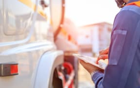 Generic picture of truck driver recording / logging information.