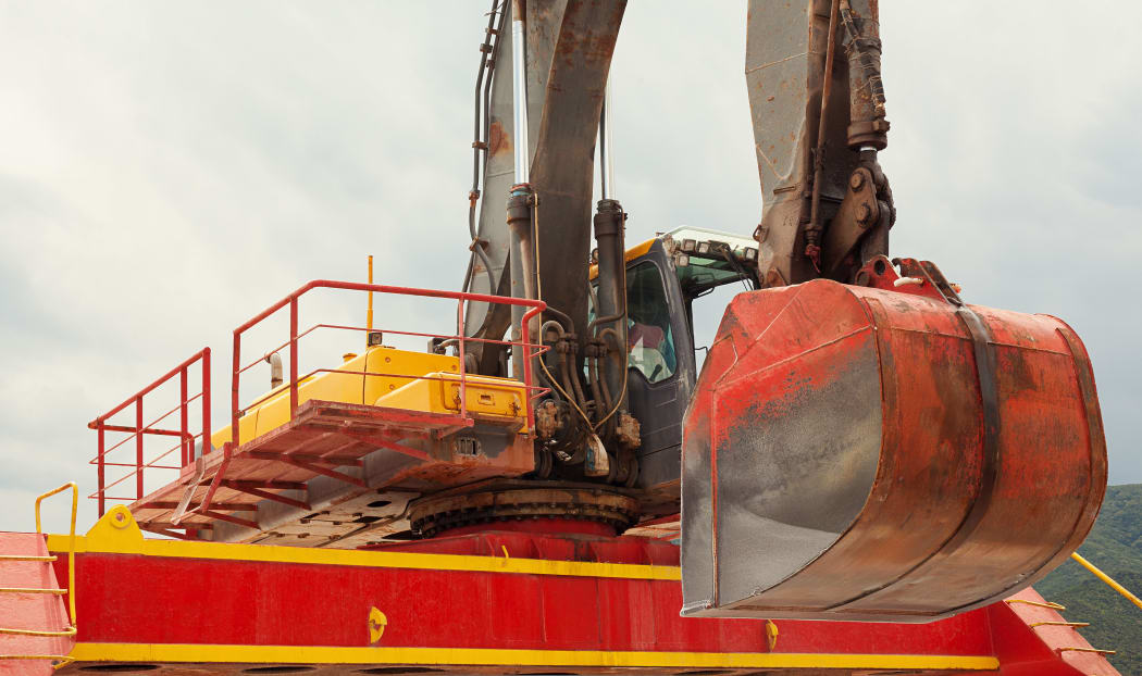 Big colorful excavator of sea tanker, closeup view.