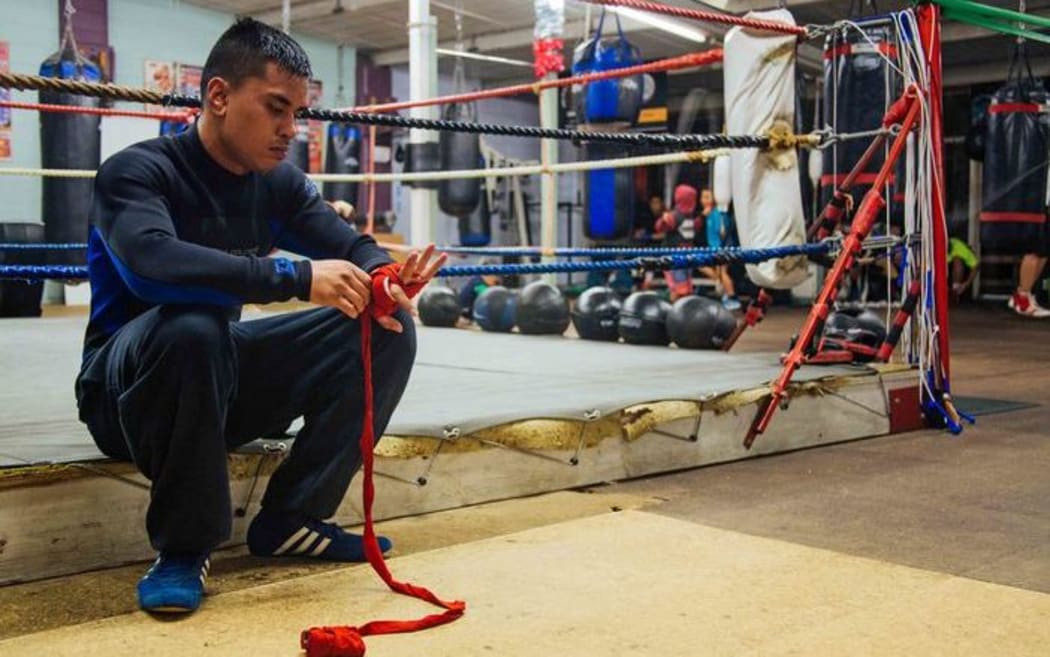 Mose Auimatagi Jnr wraps up his hand before stepping in the ring.