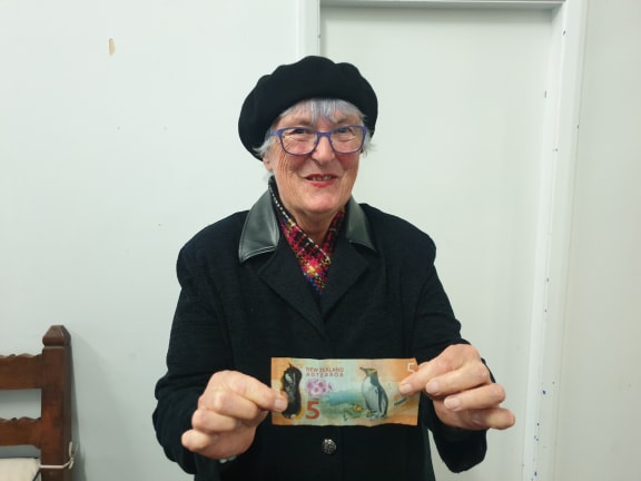 Grandmother Mary Lochore had already chipped in $10 to help pay for stethoscopes for midwives, here she waves $5 more.