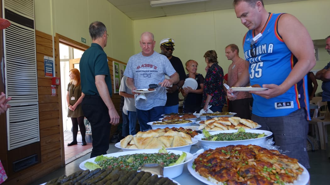 Volunteers having lunch at a church hall where they were briefed about Syrian culture and history.