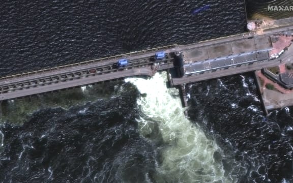 A satellite image shows a roadway and section of Nova Khakovka dam in south Ukraine. Ukrainian President Volodymyr Zelensky will urgently convene his Security Council on June 6, 2023 after an explosion at the Kakhovka hydroelectric dam in the south of the country.