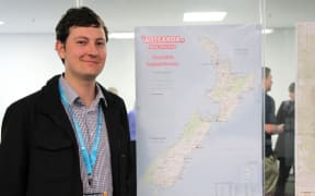 Andrew Douglas Clifford with his wall poster te reo map.