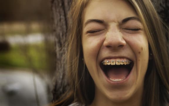 girl in braces laughing