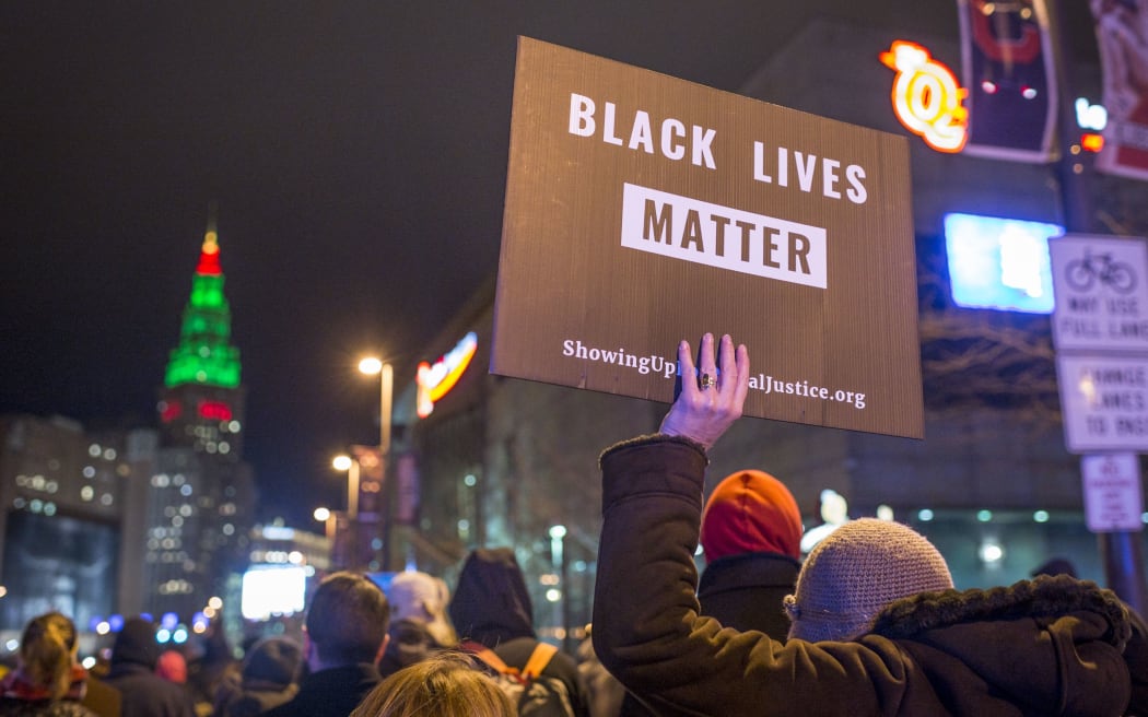 Demonstrators march on Ontario St the day after a grand jury declined to indict Cleveland police officer Timothy Loehmann for the fatal shooting of Tamir Rice.