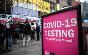 Crowds line up in Times Square on 18 December 2021 to get tested for Covid-19 as cases sharply rise in the city ahead of the holidays.