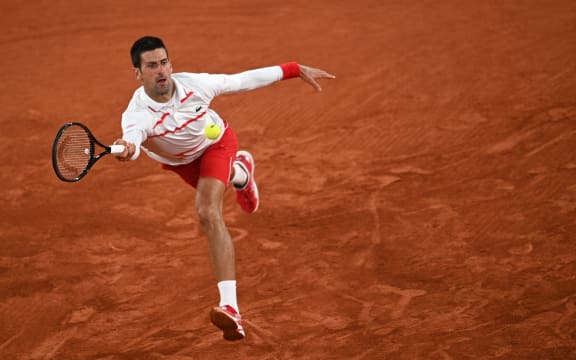 Serbia's Novak Djokovic returns the ball to Colombia's Daniel Elahi Galan during their men's singles third round tennis match on Day 7 of the 2020 French Open tennis tournament in Paris on October 3, 2020.