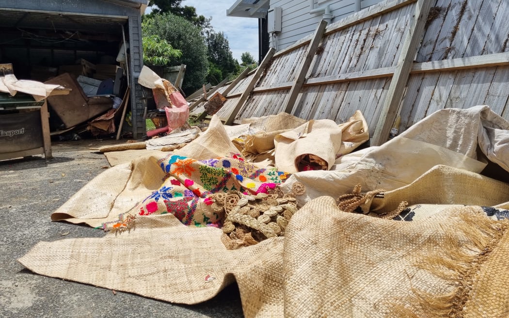 Vasiti Pele and her husband Siosaia's sodden belongings piled outside their West Auckland home after their house flooded.