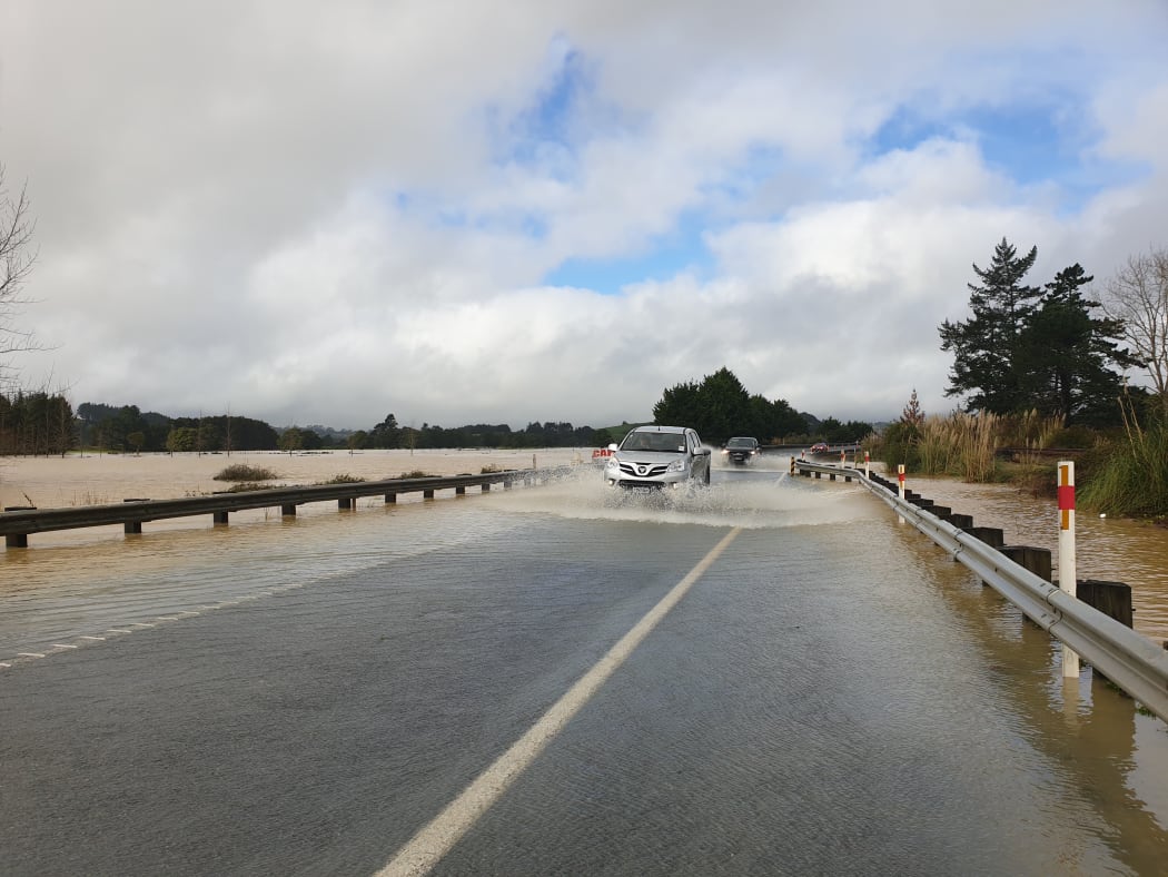 A car drives through flooding in Northland on 18 July.