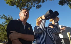 Doug and Vikki Pflaum scan the fire from the flat to see whether or not the flames have reached their house in the Port Hills.