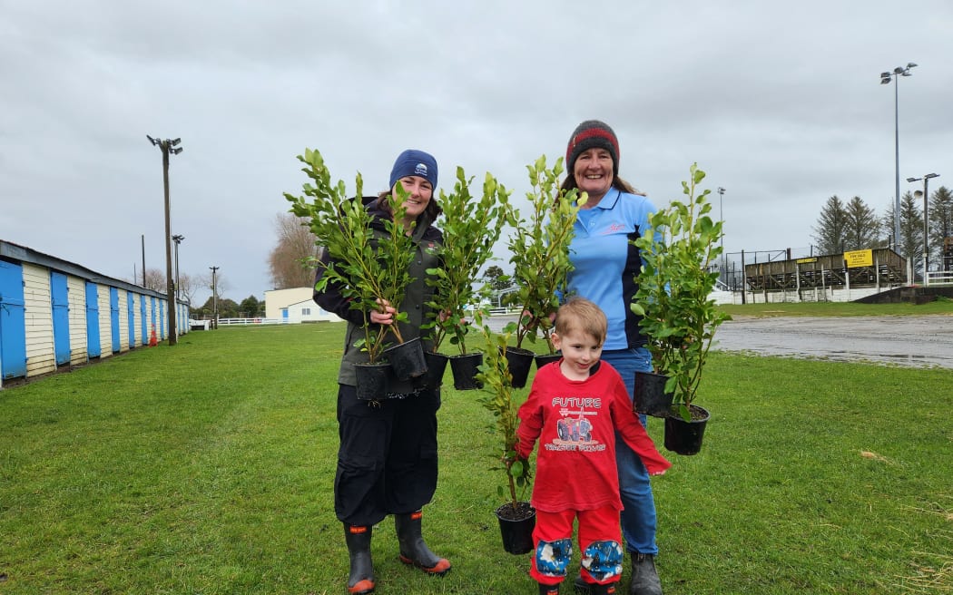 TRC Riparian Team Leader Holly Laundon, left, with son Charlie, 4, and mum Vicki Jagersma at the Stratford A&P Showgrounds, one of the council's plant depots. Vicki is secretary for the A&P Association which runs the depot when plants are dispatched to landowners and farmers by a team of volunteers.