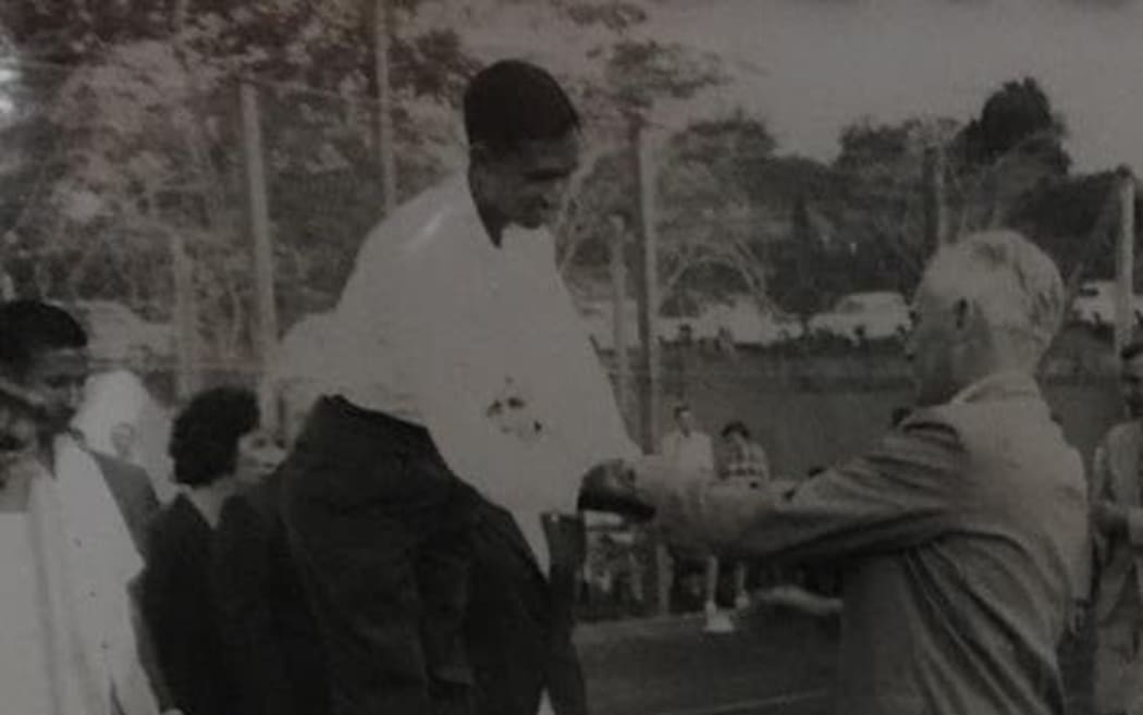 Sir Keith Maddocks, Governor of Fiji, presents Rahim Zullah with his tennis gold medal at the first-ever pacific Games in 1963