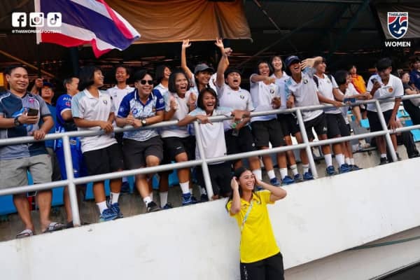 Natalie Olson poses for a photo with the football crowd in Thailand.