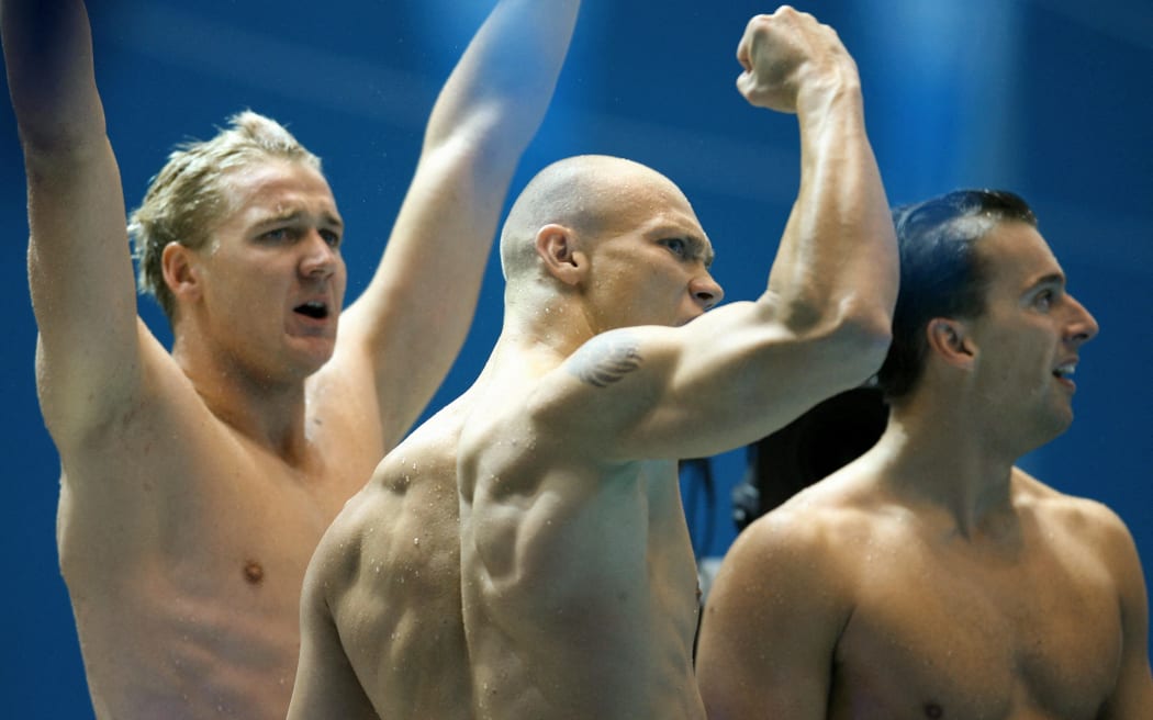 (L to R) Australia's Brenton Rickard, Michael Klim and Matthew Welsh cheer on teammate Eamon Sullivan as they head to victory in the men's 4x100 medley relay at the Commonwealth Games in Melbourne, 21 March 2006. Australia finished first, England second and Scotland took home the bronze.    AFP PHOTO/GREG WOOD (Photo by GREG WOOD / AFP)