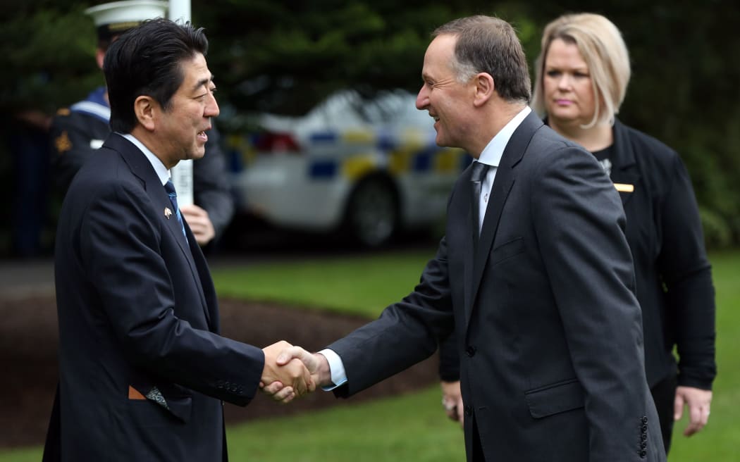 Shinzo Abe shakes hands with New  John Key at Government House in Auckland.