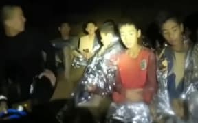 The boys can be seen introducing themselves next to a diver in a wetsuit.