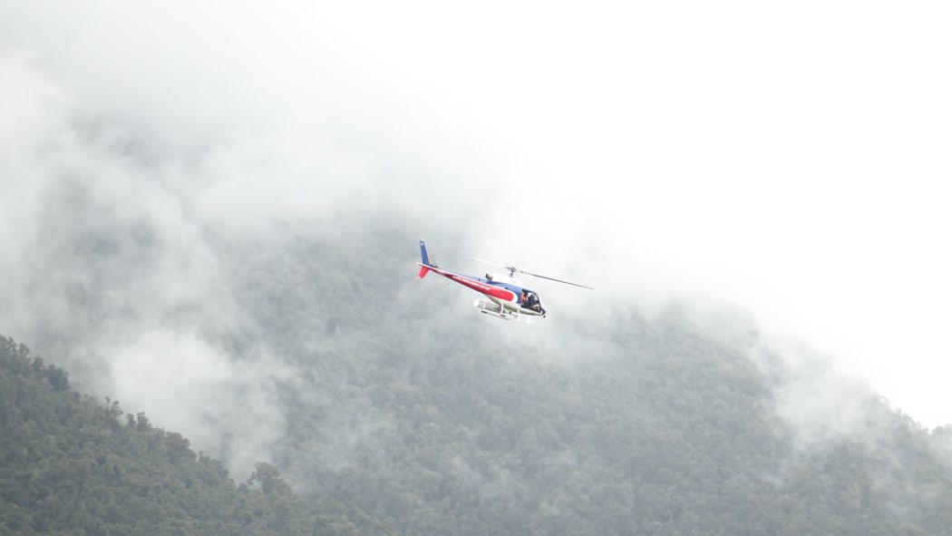 Rescue helicopter attends to the last three fatal crash victims on Fox Glacier.