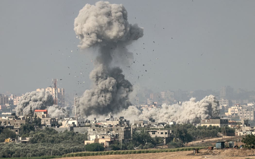 A picture taken from the southern Israeli city of Sderot on 23 October 2023, shows smoke and debris ascending over the northern Gaza Strip following an Israeli strike, amid the ongoing battles between Israel and the Palestinian group Hamas.