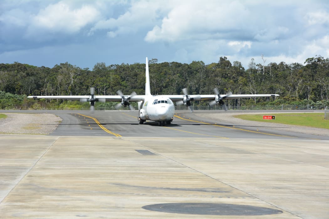 Flight arriving at Komo airfield in PNG Southern Highlands with humanitarian relief supplies