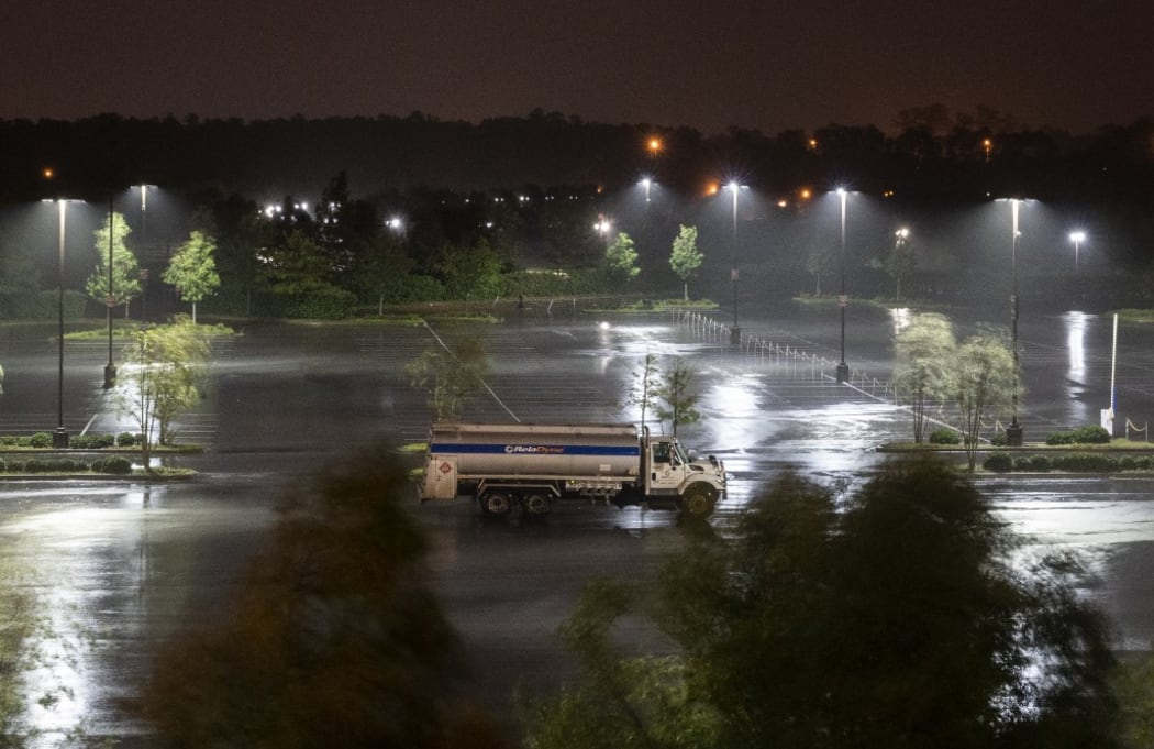 A single truck is parked in an open lot as heavy rains from hurricane Laura fall in Lake Charles, Louisiana.