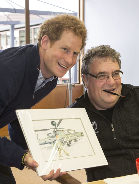 Grant Sharman, who holds a brush in his mouth, gave Prince Harry this picture.