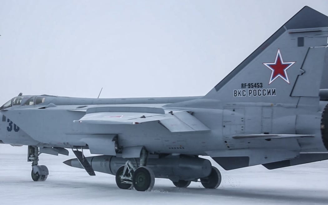 This handout video grab released by the Russian Defence Ministry on February 19, 2022, shows a MiG-31K fighter of the Russian air force carrying a Kinzhal hypersonic cruise missile during the Grom-2022 Strategic Deterrence Force exercise at an undefined location in Russia. Russia on February 19 successfully test-fired its latest hypersonic ballistic missiles, cruise missiles, and nuclear-capable ballistic missiles as part of "planned exercises," the Kremlin said, as tensions soar over Ukraine. (Photo by Handout / Russian Defence Ministry / AFP) / RESTRICTED TO EDITORIAL USE - MANDATORY CREDIT "AFP PHOTO /Russian Defence Ministry" - NO MARKETING - NO ADVERTISING CAMPAIGNS - DISTRIBUTED AS A SERVICE TO CLIENTS