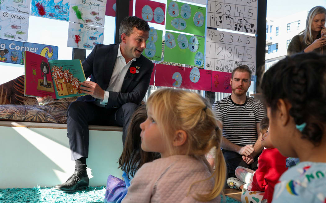 Associate Education Minister David Seymour reads "Oi Frog!" to children at an Early Childhood Education centre in Wellington.