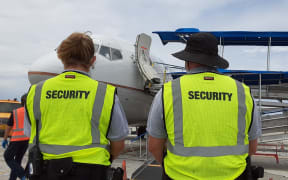 US Army security officials watch as Marshallese arrive on United Airlines flight from Hawaii - Oct 31