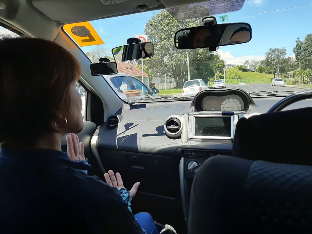 Susan takes Islam for her driving lesson before she sits her restricted test.