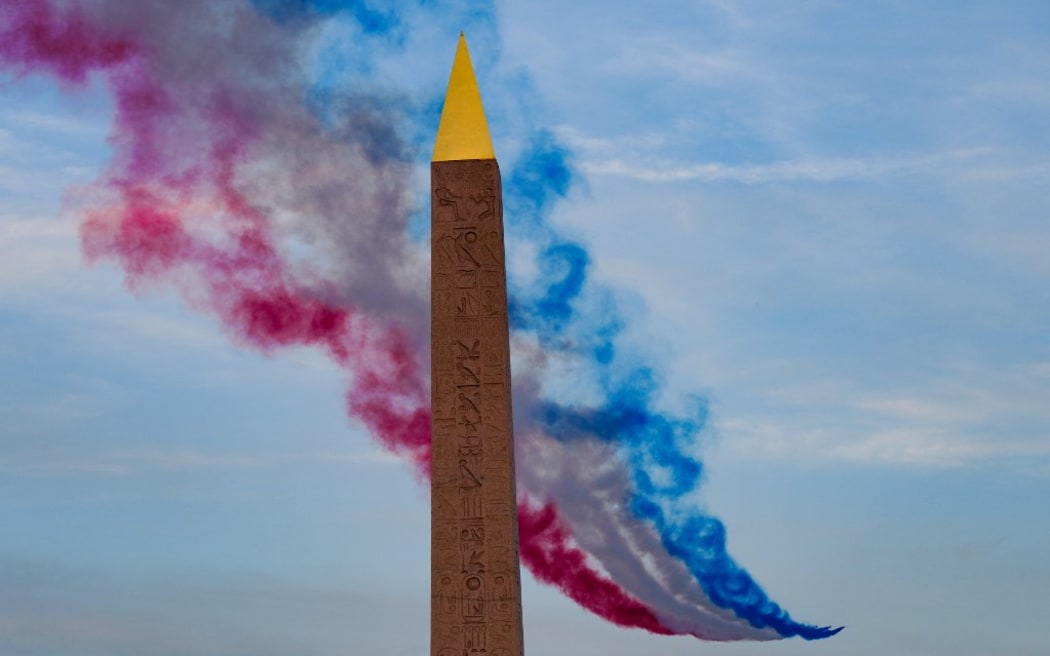 French Air Force Elite acrobatic flying team "Patrouille de France" performs near the Obelisque de Louxor (Luxor Obelisk) during the Paris 2024 Paralympic Games Opening Ceremony in Paris on August 28, 2024. (Photo by Dimitar DILKOFF / AFP)