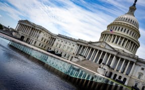 A view of the US Capitol in Washington, DC, on June 30, 2025. US senators began voting Monday on Donald Trump's flagship spending bill, as the deeply divisive package -- expected to slash social programs for the poor and add an eye-watering $3 trillion to the national debt -- entered its frenetic home stretch. Trump wants what he calls the "One Big Beautiful Bill" to extend his expiring first-term tax cuts at a cost of $4.5 trillion to the budget, boost military spending and fund his plans for unprecedented mass deportations and border security. (Photo by Jim WATSON / AFP)
