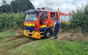 A fire truck at the paddock where a microlight has crashed.