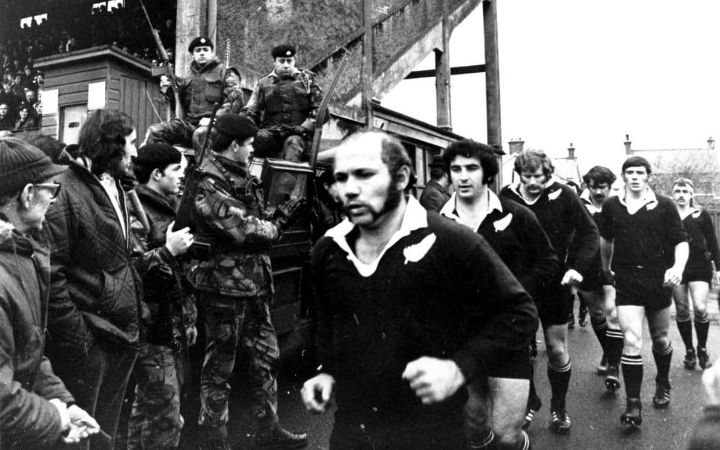 Joe Karam and Sid Going run out onto the field during the All Black Tour of the UK and France, 1972-1973.